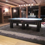 Pool/Snookertisch 9tf - Eigenproduktion im Kundenauftrag für ein 5-Sterne Hotel in Lech am Arlberg, Design: Bezug mit schwarzem Leder und aufgesetzten Chromeleisten 
